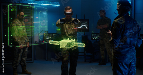 Military men controlling holographic model of drone