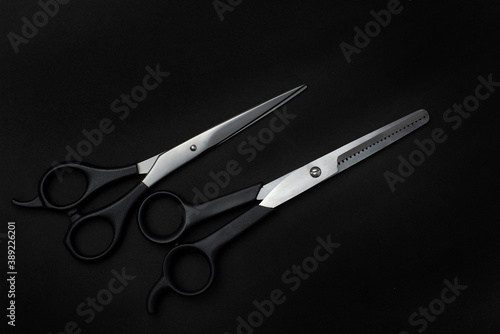Some barber scissors with black background


