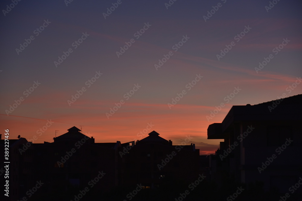 Orange Sunset Glowing in the Sky Over the Buildings Orange Sunset Glowing in the Sky Over the Buildings