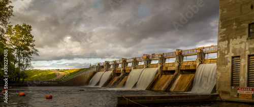 Water flowing over Barton dam on a cloudy morning photo