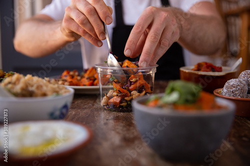 Chef preparing healthy food to take away at home