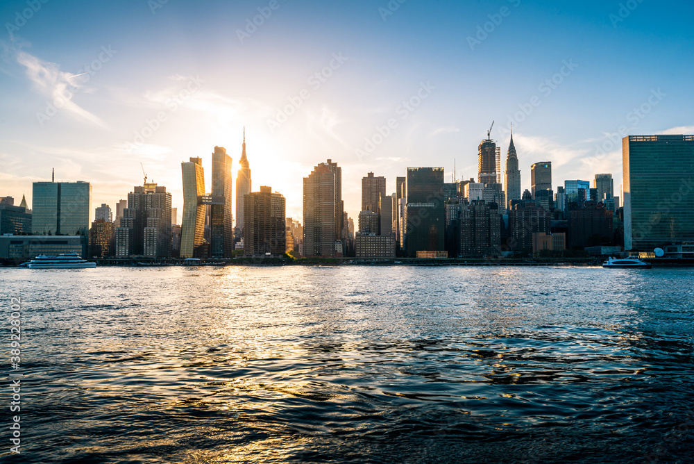 Manhattan city skyline seen with the setting sun on a beautiful sunny day