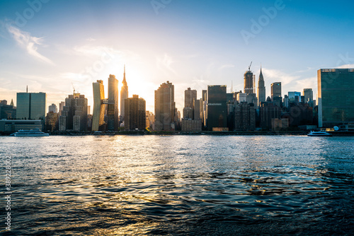 Manhattan city skyline seen with the setting sun on a beautiful sunny day