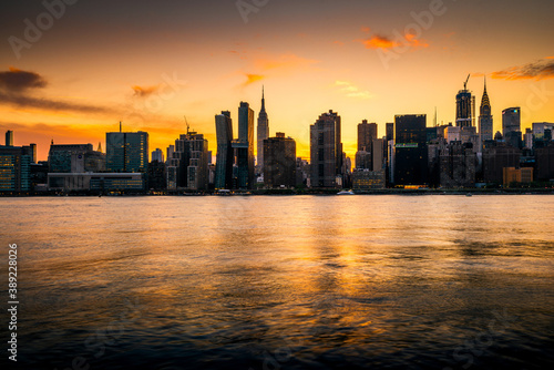 Panoramic view of the New York City skyline silhouette at sunset