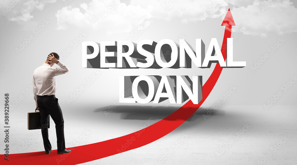 Rear view of a businessman standing in front of PERSONAL LOAN inscription, successful business concept Rear view of a businessman standing in front of PERSONAL LOAN inscription, successful business concept