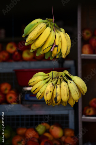 Banana hanging in a shop. Ripe yellow banana ready to eat, healthy diet. Ripe yellow Asian bananas.