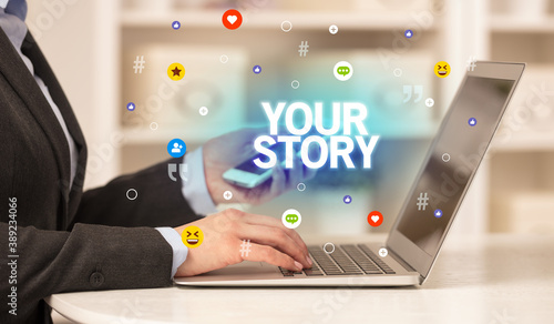 Freelance woman using laptop with YOUR STORY inscription, Social media concept