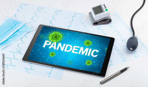 Close-up view of a tablet pc with PANDEMIC inscription, microbiology concept