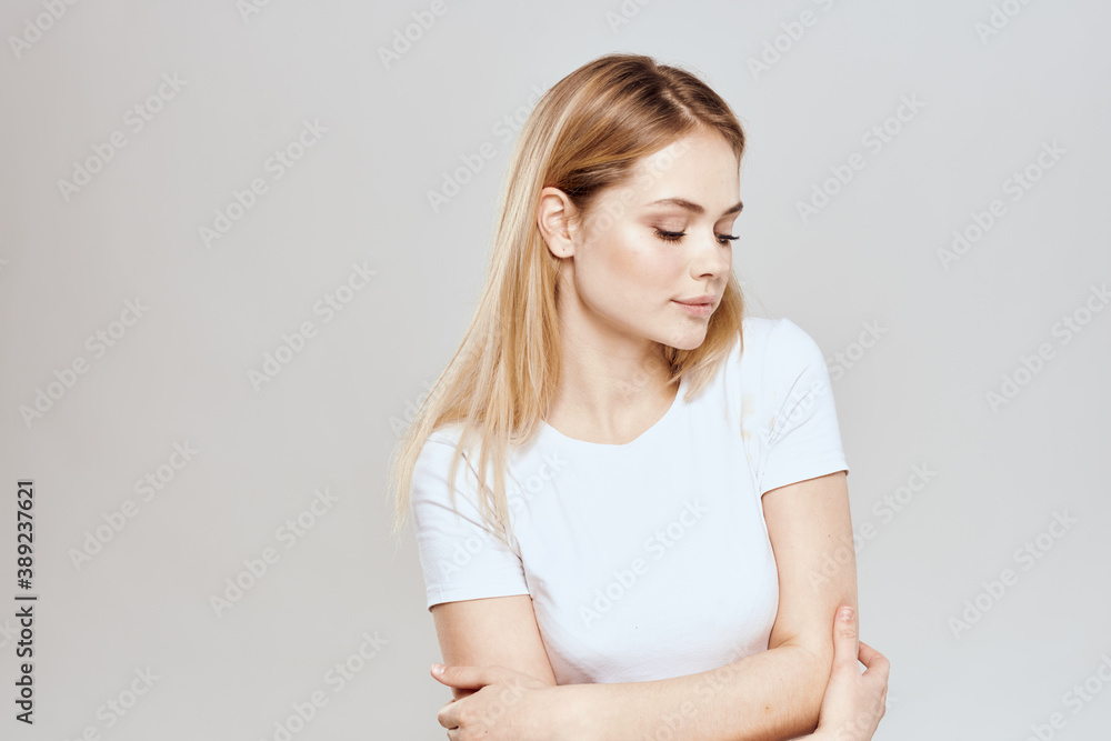 Cute blonde white t-shirt gesture with hands lifestyle light background Cute blonde white t-shirt gesture with hands lifestyle light background