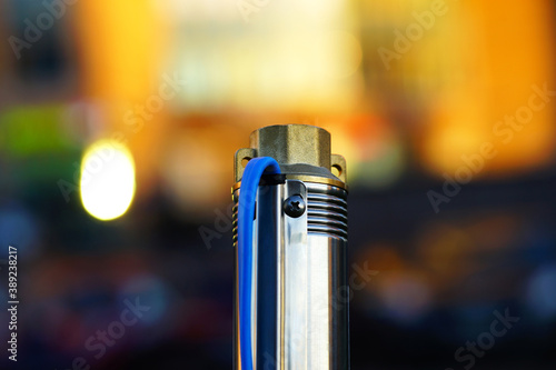 Well centrifugal pump on a bright background. Submersible pump for wells.