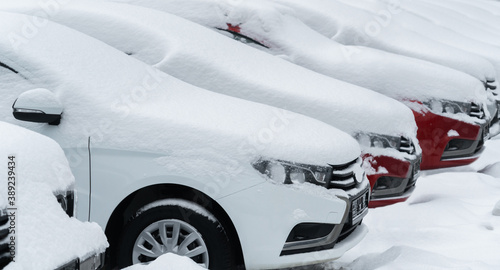 Snow covered parked cars. Winter season 