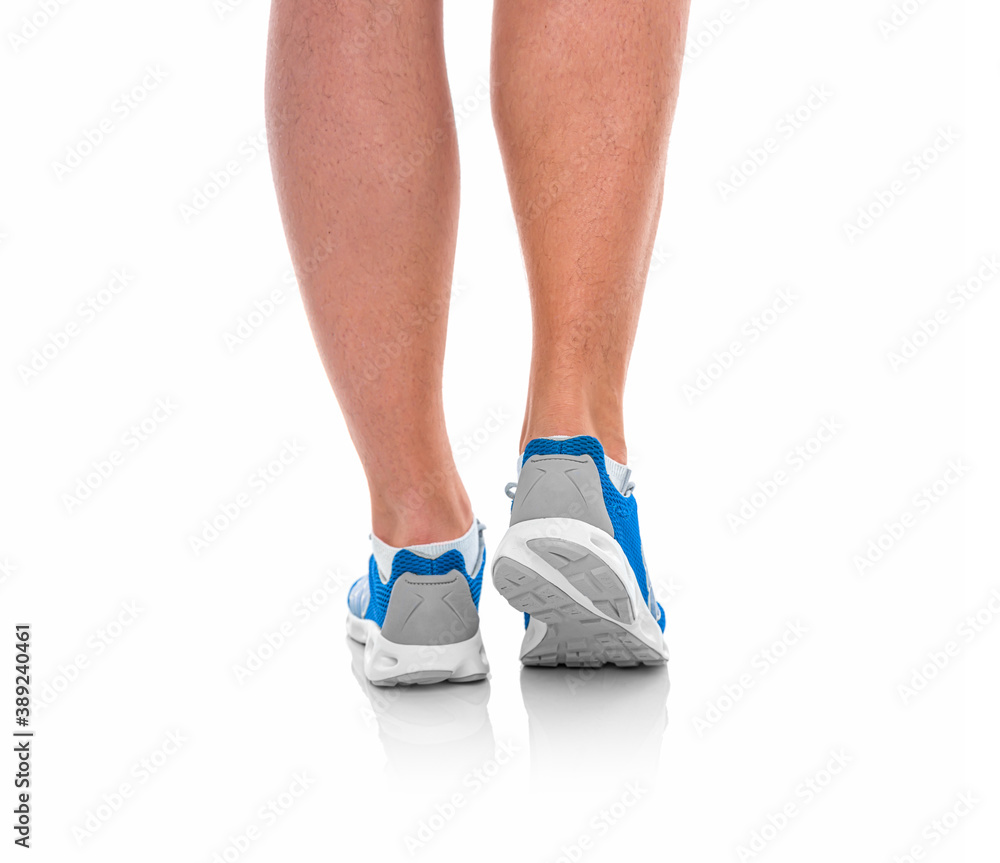 Male legs in sneakers on a white background. Male legs in sneakers on a white background.