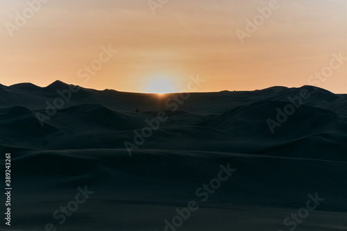 Sunset in the huacachina desert in Peru