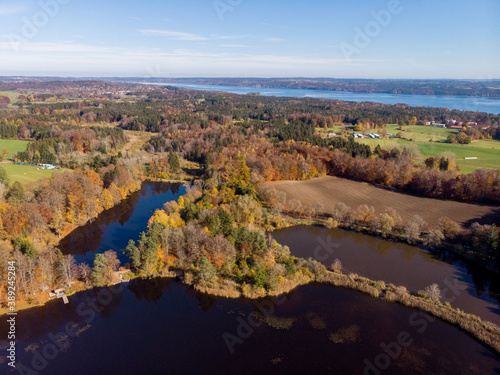 Aerial view of 4 lakes in autumn against a blue sky with clouds