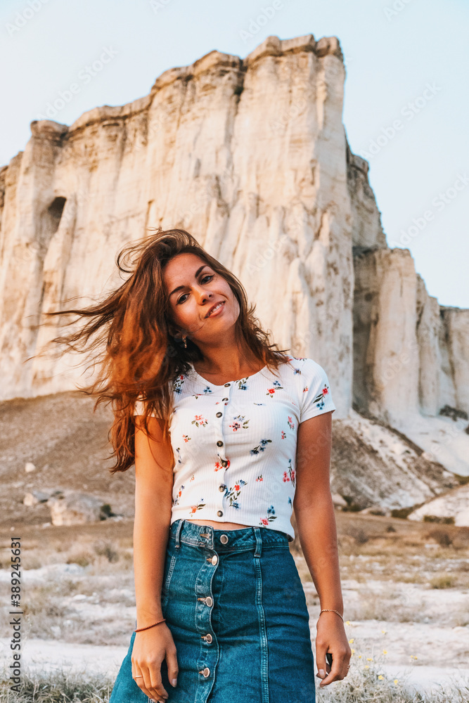 Portrait of a charming woman in a skirt at sunset on a White rock background in Crimea Portrait of a charming woman in a skirt at sunset on a White rock background in Crimea