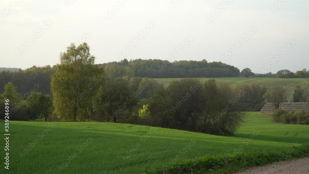 Farmland in autumn. Panoramic landscape in the countryside with a scenic view from the hill to the agricultural land in a valley near the gravel road. Farmland in autumn. Panoramic landscape in the countryside with a scenic view from the hill to the agricultural land in a valley near the gravel road.