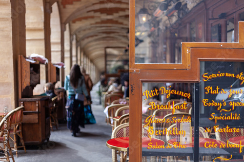 Photography Paris cafe with written signs on glass (translation: Petit Dejeuner means breakf