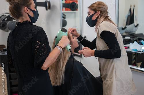 Hairdresser working a woman customer hair