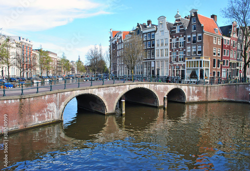 Bridge over the canal in Amsterdam and old houses on the waterfront