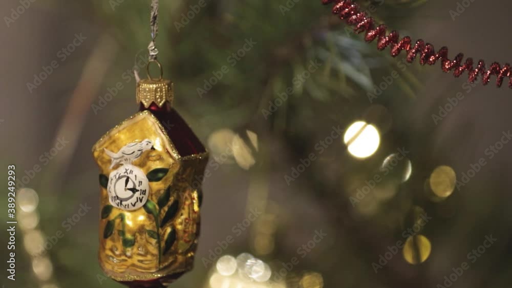 Christmas toy on the Christmas tree. Close-up. Blurred background with glowing colored lights. Smooth camera movement Christmas toy on the Christmas tree. Close-up. Blurred background with glowing colored lights. Smooth camera movement