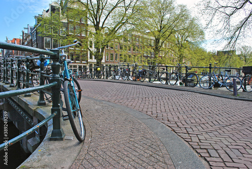 Bridge over the river channel in Amsterdam and parked bicycles