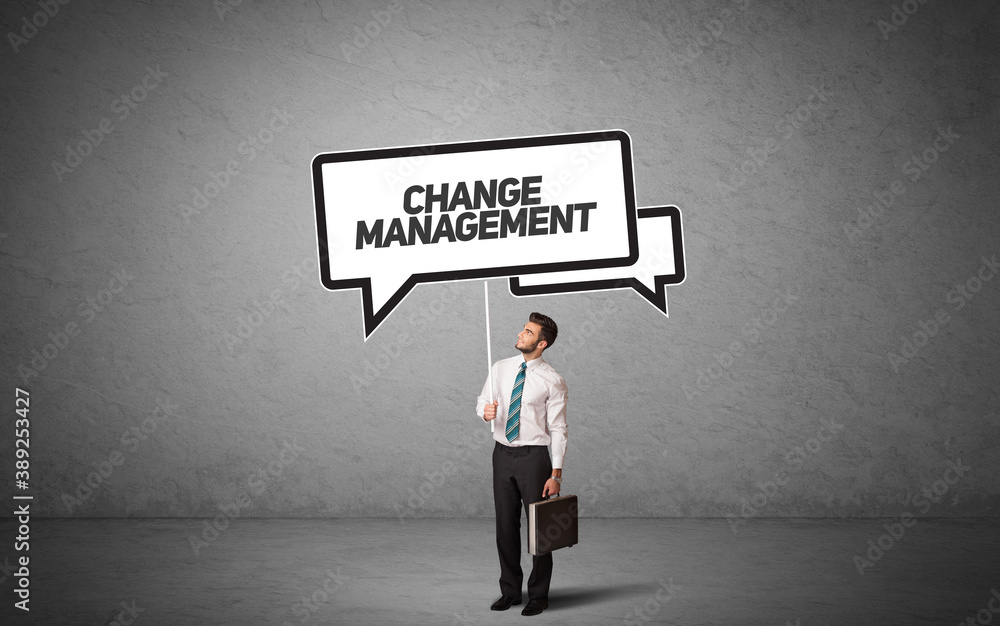 Young business person in casual holding road sign with CHANGE MANAGEMENT inscription, new business idea concept Young business person in casual holding road sign with CHANGE MANAGEMENT inscription, new business idea concept