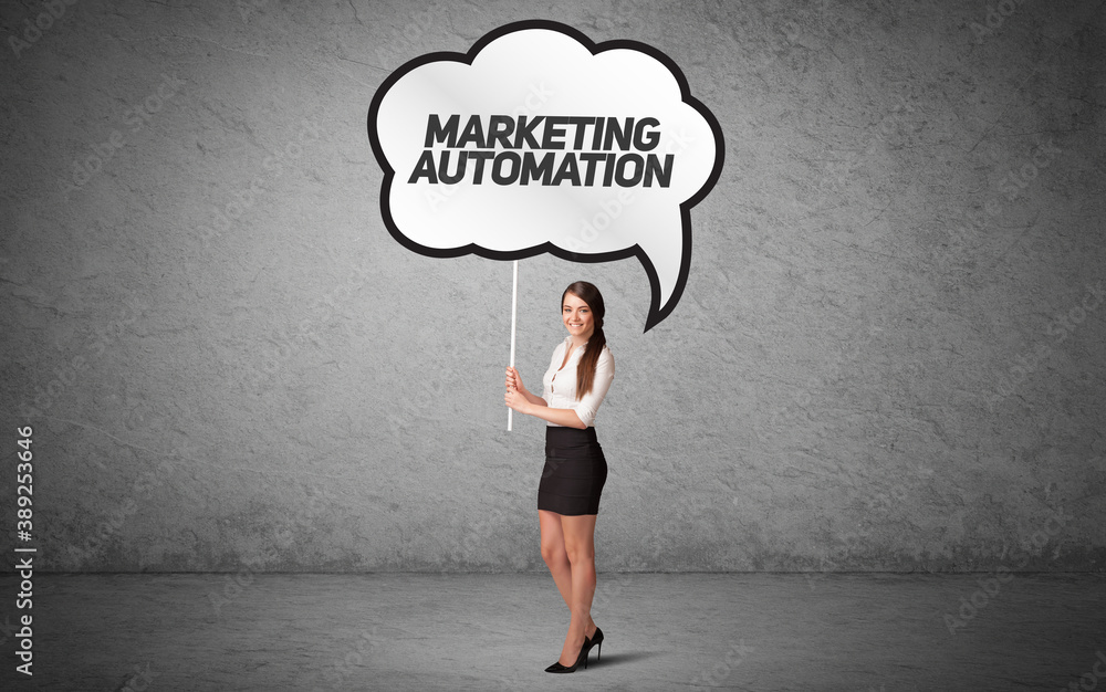 Young business person in casual holding road sign with MARKETING AUTOMATION inscription, new business idea concept Young business person in casual holding road sign with MARKETING AUTOMATION inscription, new business idea concept