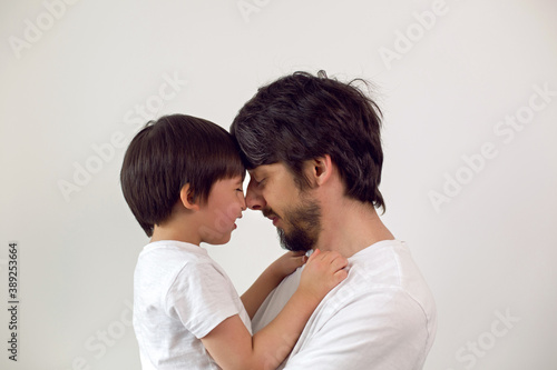 father and son on a white background at home