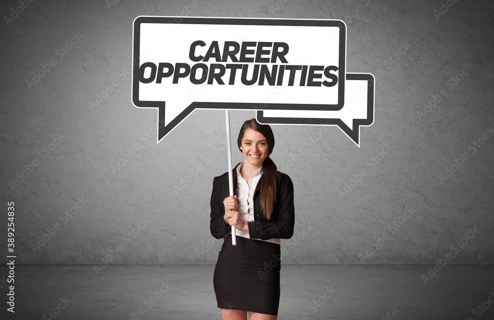 Young business person in casual holding road sign with CAREER OPPORTUNITIES inscription, new business idea concept Young business person in casual holding road sign with CAREER OPPORTUNITIES inscription, new business idea concept