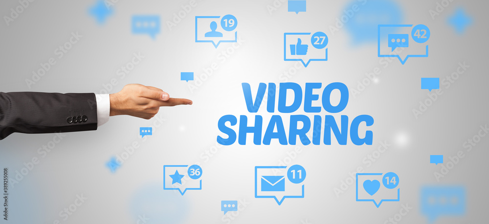 Close-Up of cropped hand pointing at VIDEO SHARING inscription, social networking concept Close-Up of cropped hand pointing at VIDEO SHARING inscription, social networking concept
