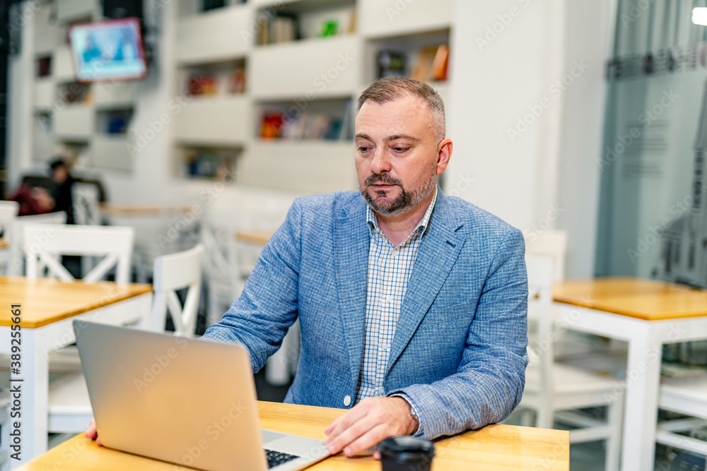 Senior businessman working on laptop computer. Confident CEO at office. Senior businessman working on laptop computer. Confident CEO at office.