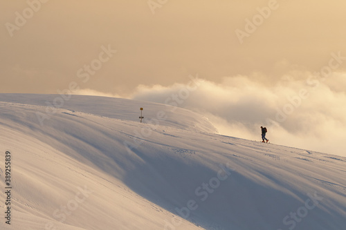Alpine skiing in the mountains with clouds