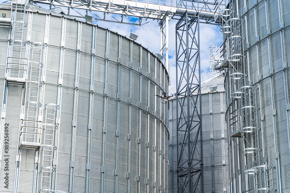 Fototapeta premium Industrial agriculture elevators with harvested grain. Grain cooperative. Closeup.