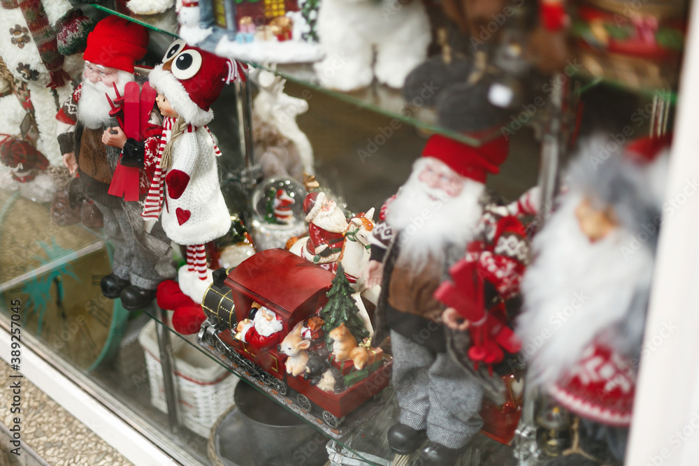 Stylish santa claus, reindeer and other festive christmas toys in window store