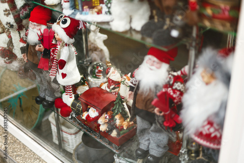Stylish santa claus, reindeer and other festive christmas toys in window store