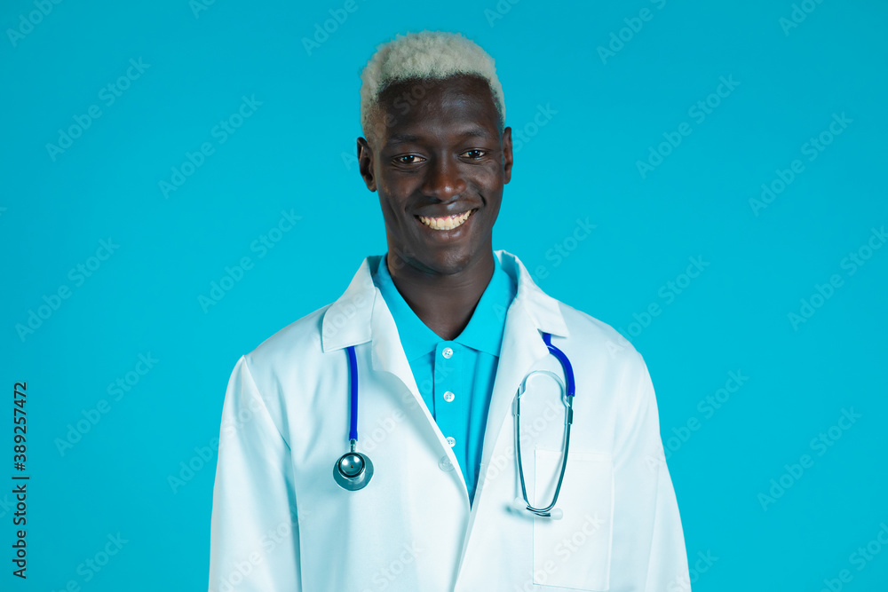 Portrait of smiling african doctor in professional medical coat . Doc man isolated on blue background. Portrait of smiling african doctor in professional medical coat . Doc man isolated on blue background.