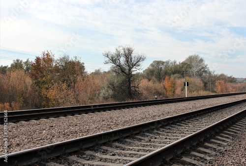 Railway tracks under the autumn sky