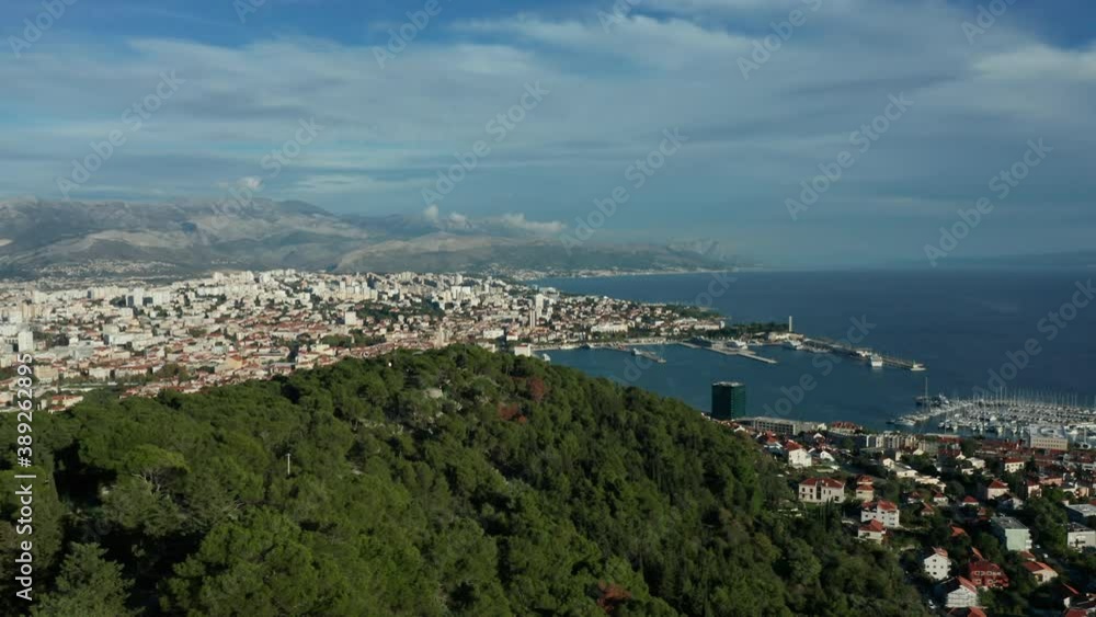 view of Split flying backwards reveal of Croatian flag atop Marjan Hill view of Split flying backwards reveal of Croatian flag atop Marjan Hill