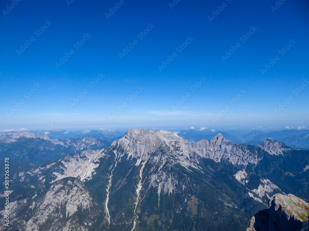 A panoramic view on endless mountain chains from top of a mountain in Hochtor region, Austrian Alps. High Alpine mountaineering. Sunny, cloudless summer day. Exploring new places. A panoramic view on endless mountain chains from top of a mountain in Hochtor region, Austrian Alps. High Alpine mountaineering. Sunny, cloudless summer day. Exploring new places.