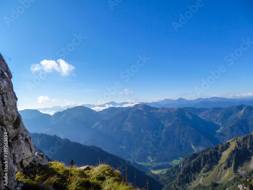 A panoramic view on endless mountain chains from top of a mountain in Hochtor region, Austrian Alps. High Alpine mountaineering. Sunny, cloudless summer day. Exploring new places.