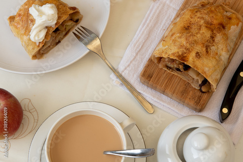 Apple strudel and coffee with milk overhead shot photo