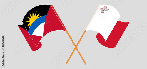 Crossed and waving flags of Antigua and Barbuda and Malta