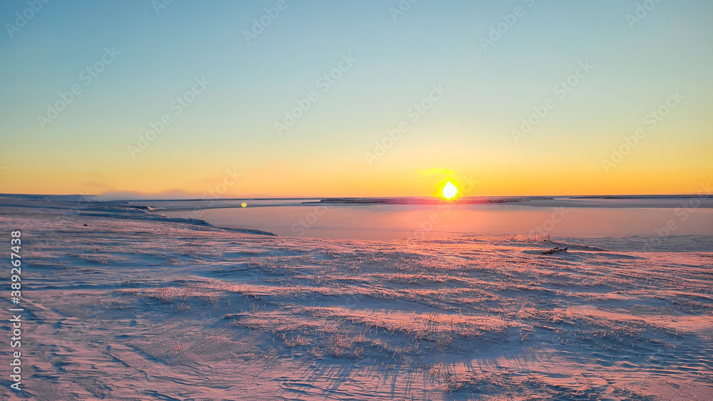 sunrise over the arctic ocean in Sachs Harbour NT cold winter day on Banks Island Canada
