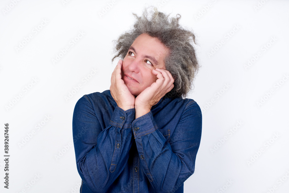 Inspired Handsome mature caucasian man with afro grey hair standing over isolated white background looking at copyspace having thoughts about future events Inspired Handsome mature caucasian man with afro grey hair standing over isolated white background looking at copyspace having thoughts about future events