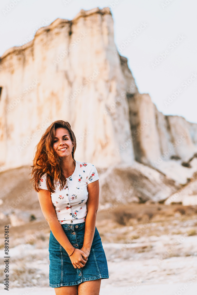 Portrait of a charming woman in a skirt at sunset on a White rock background in Crimea Portrait of a charming woman in a skirt at sunset on a White rock background in Crimea