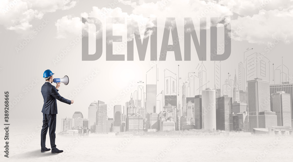 Young businessman with hard hat and DEMAND inscription, new business opportunity concept Young businessman with hard hat and DEMAND inscription, new business opportunity concept