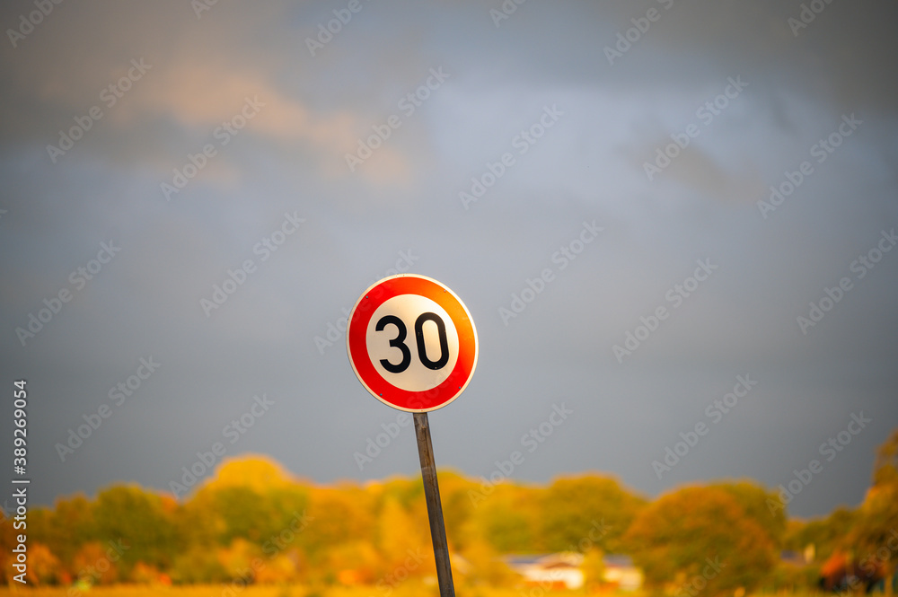 a thirties  zone sign with dark ominous clouds in the background