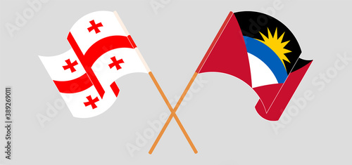 Crossed and waving flags of Antigua and Barbuda and Georgia