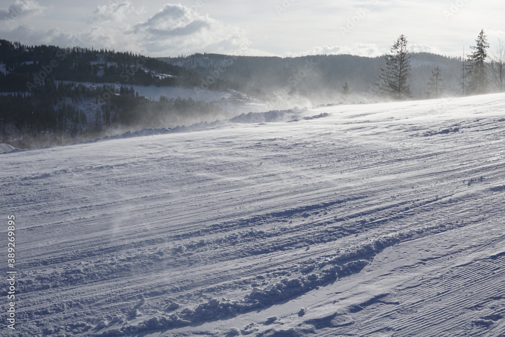 Wonderful winter landscape. Magnificent highlands on a sunny day. Winter mountain forest. Snowy mountains and beautiful blue sky. Amazing nature background. Winter postcard. Ski slope. Wind walking on Wonderful winter landscape. Magnificent highlands on a sunny day. Winter mountain forest. Snowy mountains and beautiful blue sky. Amazing nature background. Winter postcard. Ski slope. Wind walking on