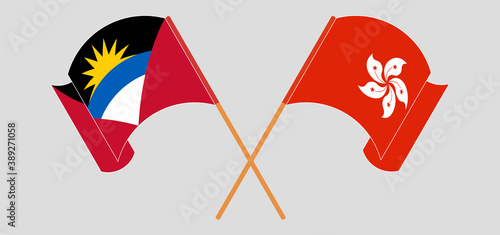 Crossed and waving flags of Antigua and Barbuda and Hong Kong